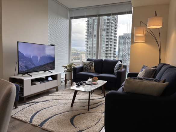 Bright urban living room with large windows, modern furniture, and scenic city views, ideal for Vancouver condos and real estate listings.