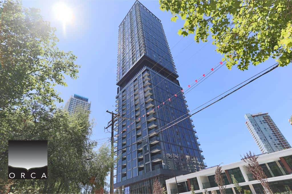 Modern high-rise condo building in downtown Vancouver, featuring glass exterior, spacious balconies, and contemporary architectural design. Perfect location for urban living and investment.