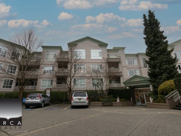 Stylish multi-unit residential building in Vancouver, BC by Orca Realty Inc., showcasing modern architecture, manicured landscaping, and convenient parking for residents.