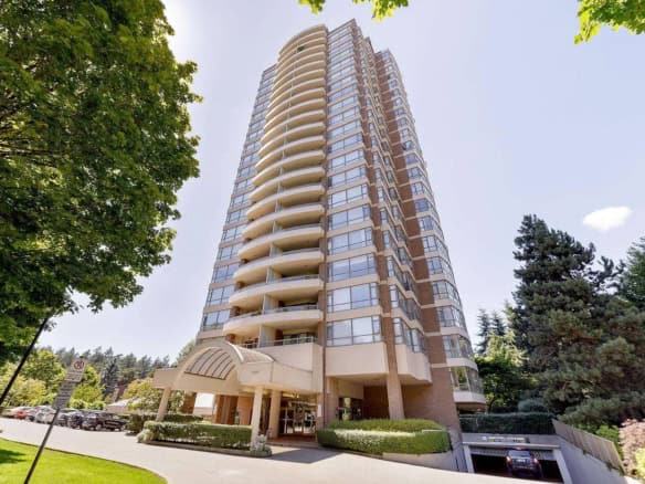 Modern high-rise residential building in Vancouver with spacious balconies and lush landscaping, offering prime real estate opportunities.