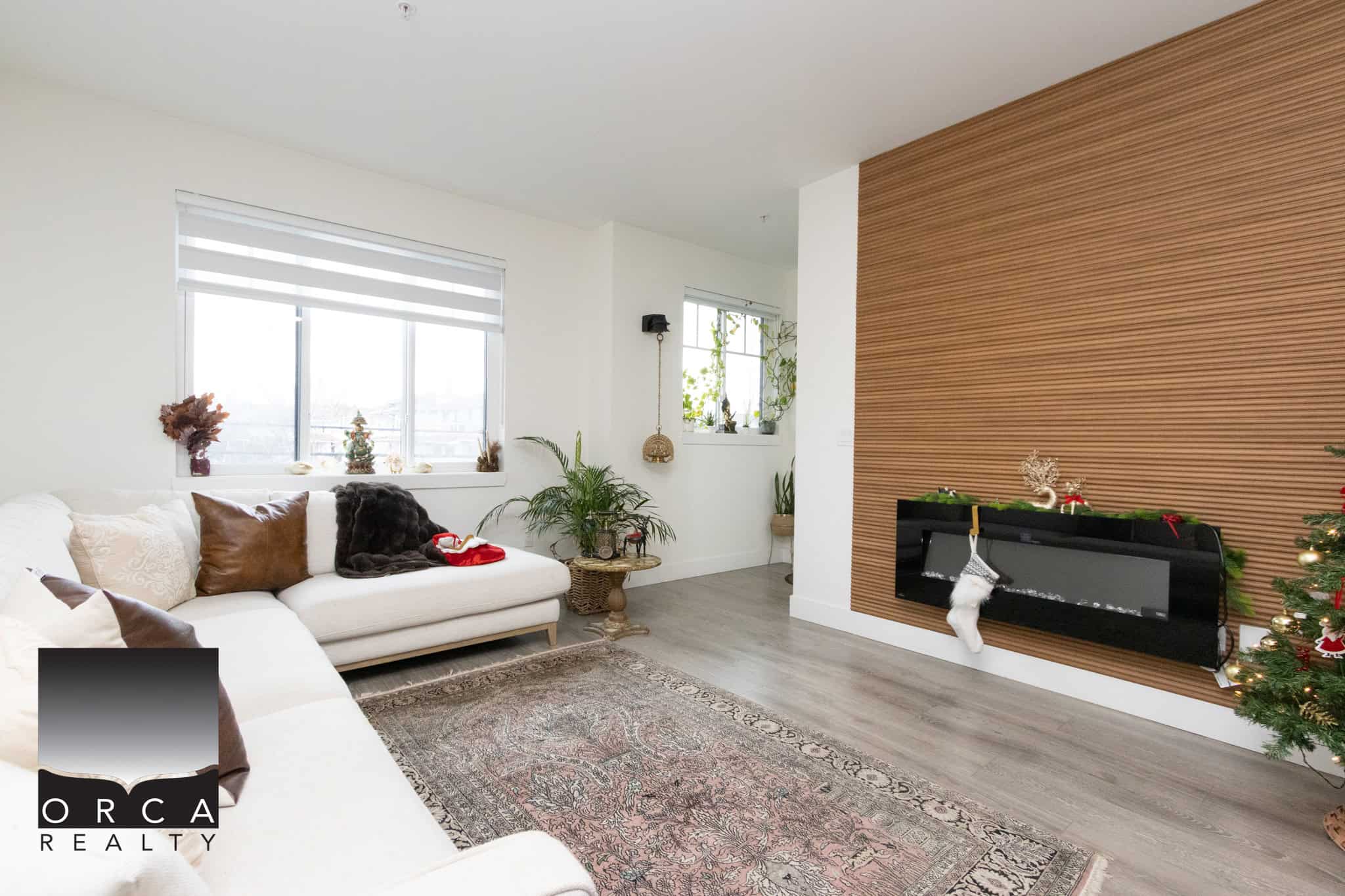 13 Bright living room with modern decor, natural light, and a cozy fireplace, perfect for family gatherings. Excellent opportunity with Orca Realty Inc. for buying or selling homes in the Vancouver area.