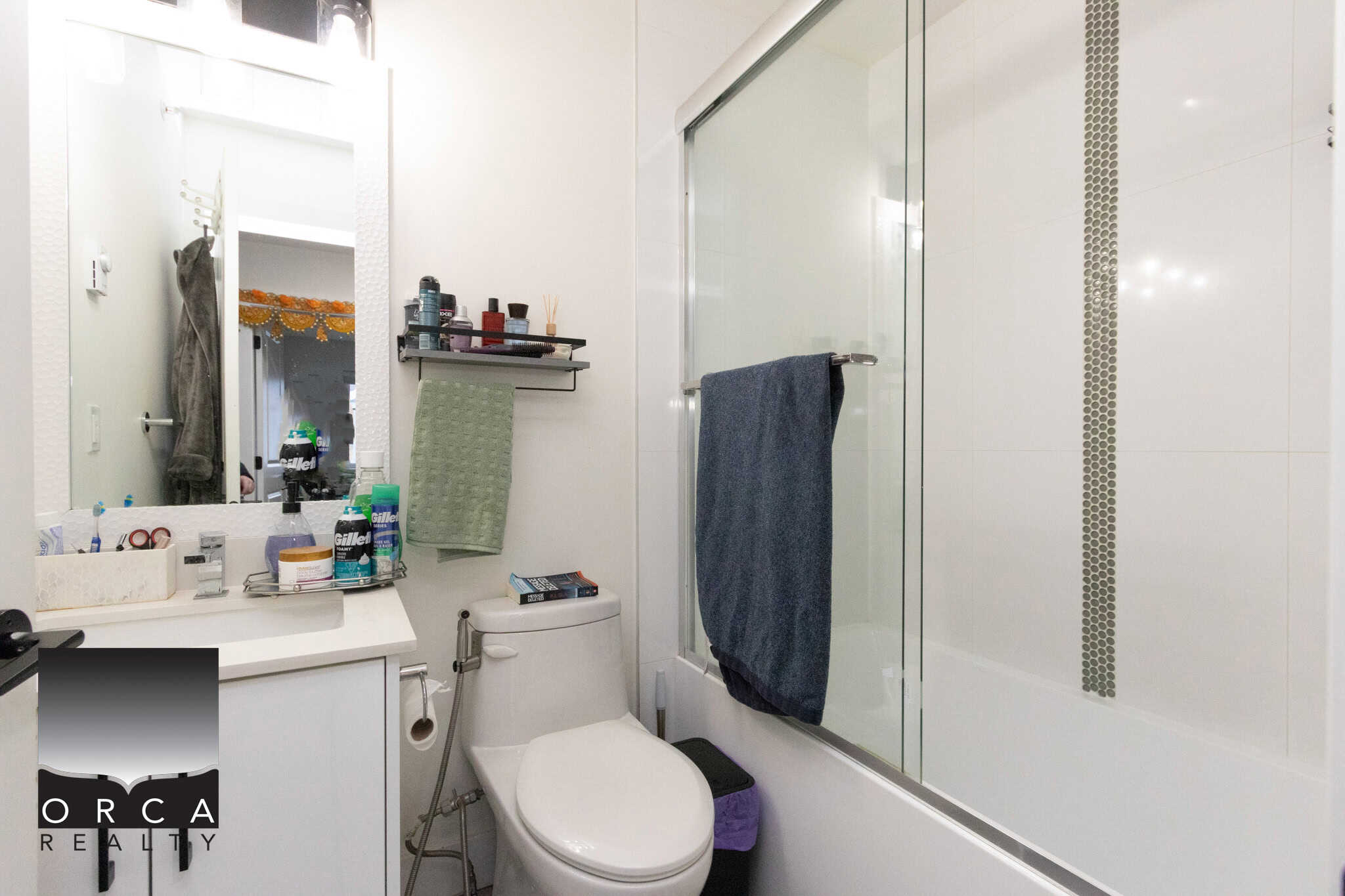17 Clean modern bathroom with white tiles, glass shower, and contemporary fixtures, perfect for luxury home living and real estate listings in BC.