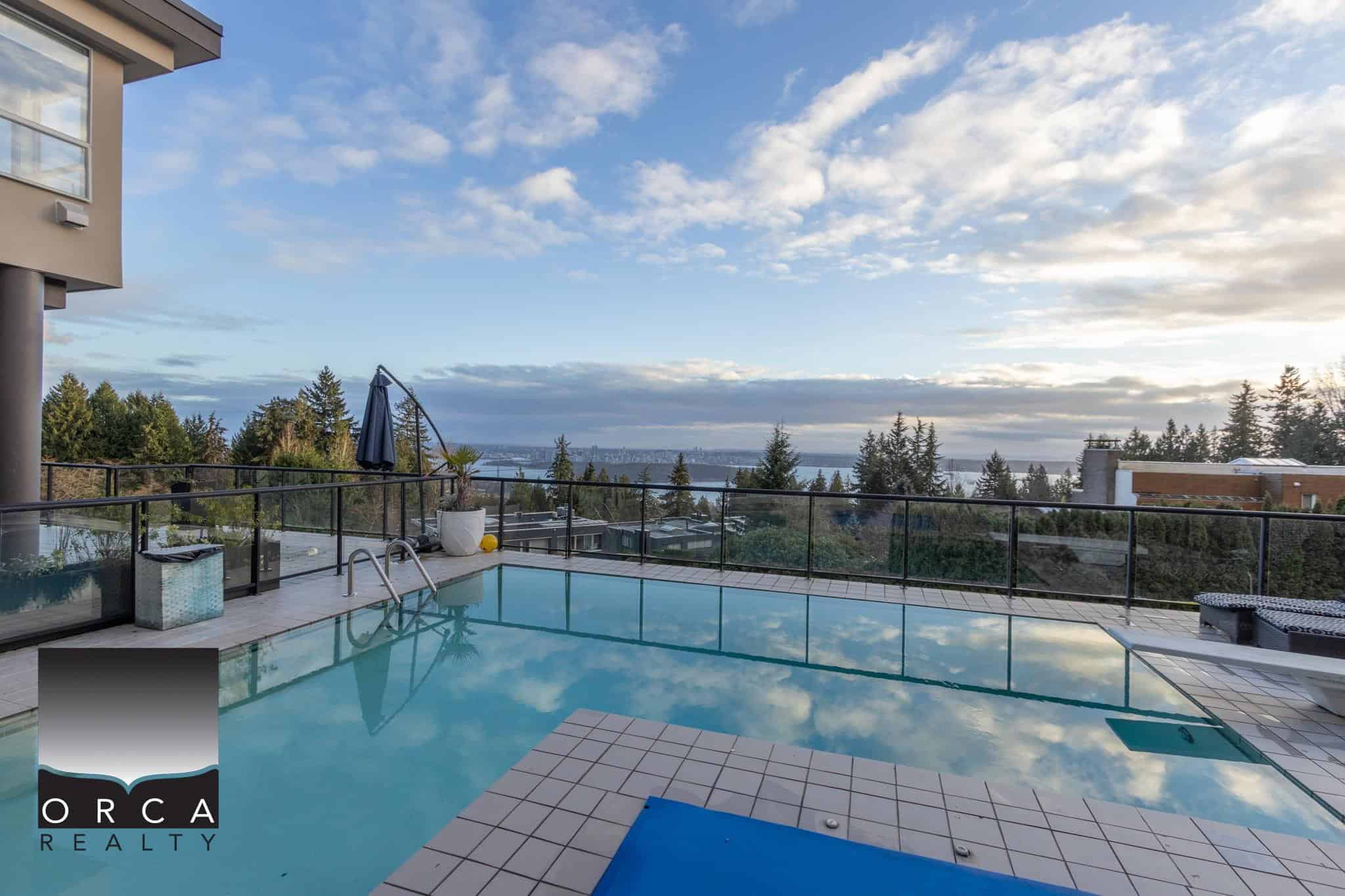 Luxurious rooftop infinity pool with scenic ocean and city views, perfect for relaxation and entertaining, featured by Orca Realty Inc. in Victoria, BC. Ideal for premium real estate listings.