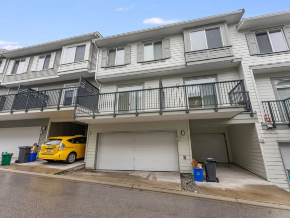 Bright modern townhouse with garage, balcony, and easy parking, ideal for families or investors seeking real estate opportunities in the Vancouver area.
