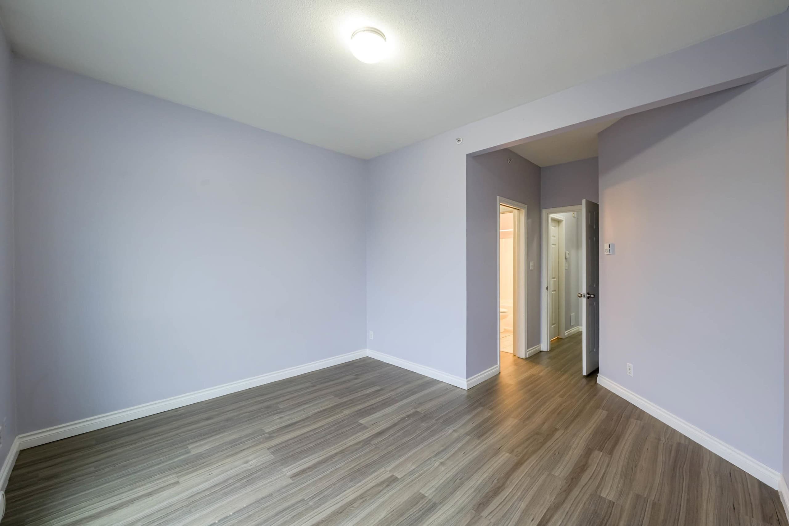 Bright and spacious living room featuring updated flooring and neutral wall colours, showcasing key features of Orca Realty Inc. properties in the Vancouver real estate market.