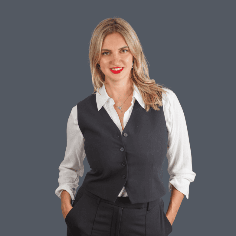 Confident female real estate agent in professional attire representing Orca Realty Inc., eager to help clients buy or sell homes in the Vancouver Island area, delivering expert real estate services.