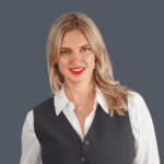 Confident female real estate agent in professional attire representing Orca Realty Inc., eager to help clients buy or sell homes in the Vancouver Island area, delivering expert real estate services.