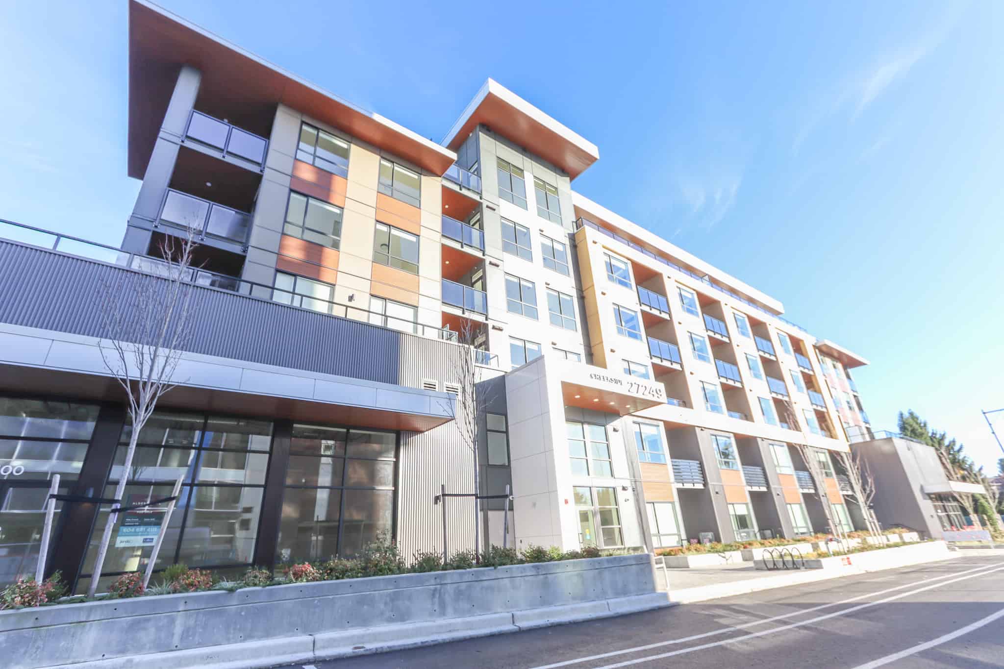 Modern multi-story residential building with contemporary architecture, large windows, and balconies, representing prime Vancouver real estate by Orca Realty Inc.