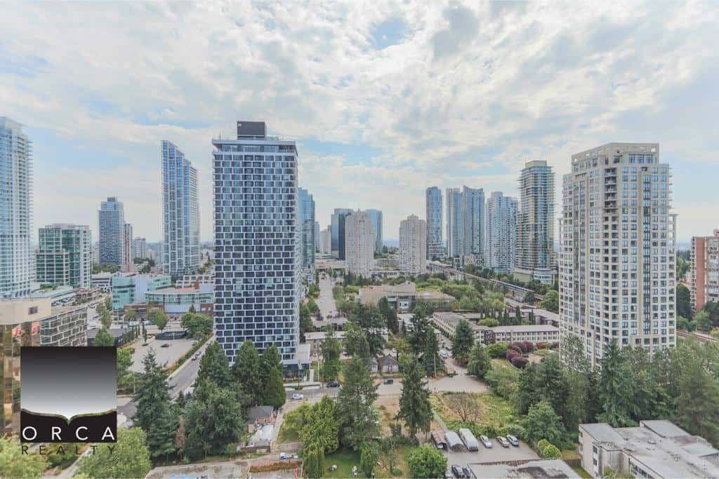 Vibrant city skyline with high-rise condos and commercial buildings in downtown Vancouver, BC. Modern urban real estate scene highlighted by Orca Realty Inc., a trusted name in BC real estate market.