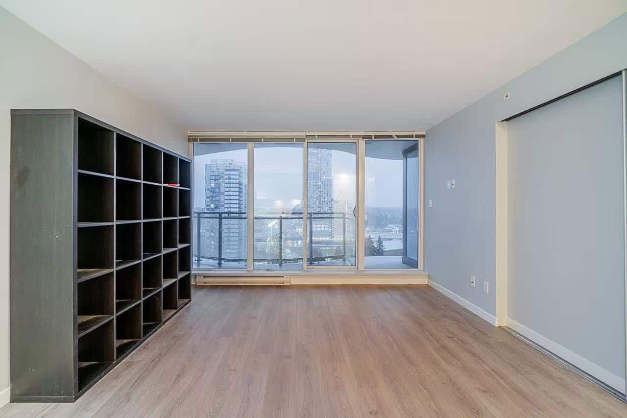 image4 Spacious apartment living room with large floor-to-ceiling windows, city views, hardwood floors, modern design, ideal for urban professionals seeking Vancouver real estate.
