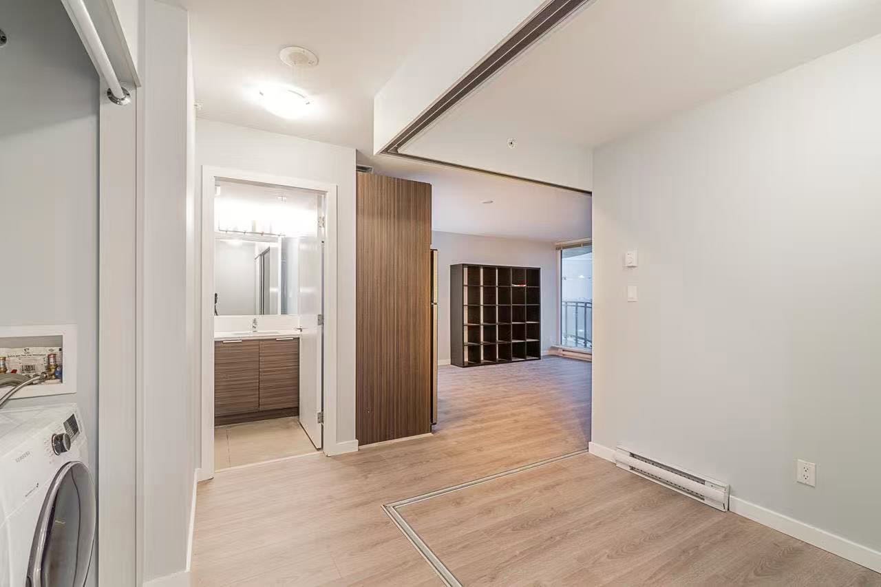image5 Bright modern apartment interior with open living space, wood flooring, and convenient laundry area, ideal for Vancouver real estate buyers seeking contemporary condos in BC.