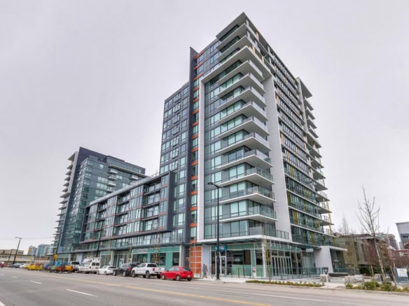 Modern high-rise residential building with spacious balconies and glass facades in downtown Vancouver, showcasing contemporary condo living in BC.
