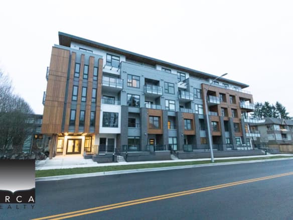 Bright modern apartment building in Vancouver with contemporary architecture, large windows, and spacious balconies, ideal for real estate investment or residential living in BC.
