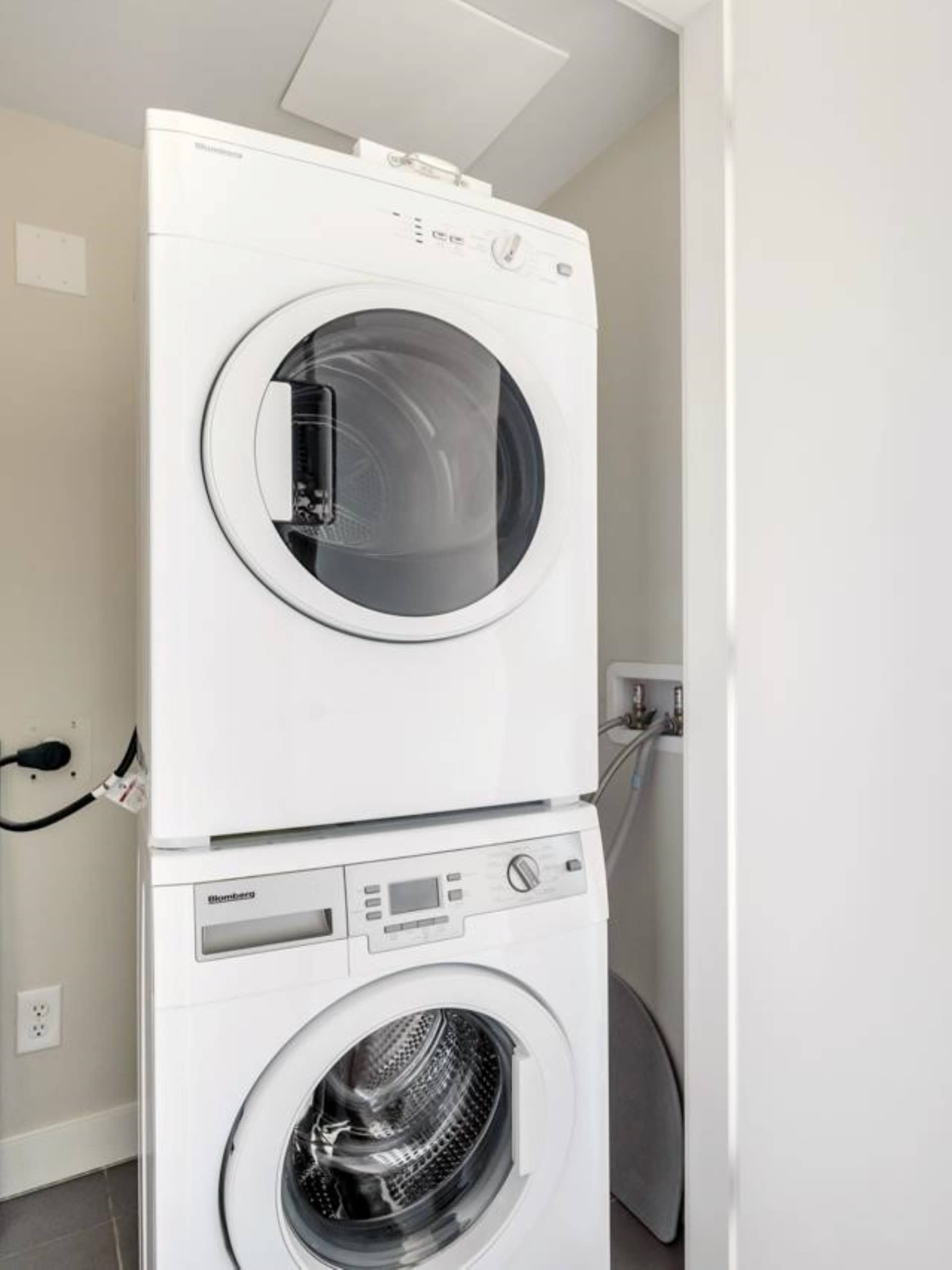 High-efficiency white washer and dryer set in a laundry room, perfect for modern homes in Ontario. Easy access, energy-saving, and reliable appliances from reputable brands for seamless laundry routines.
