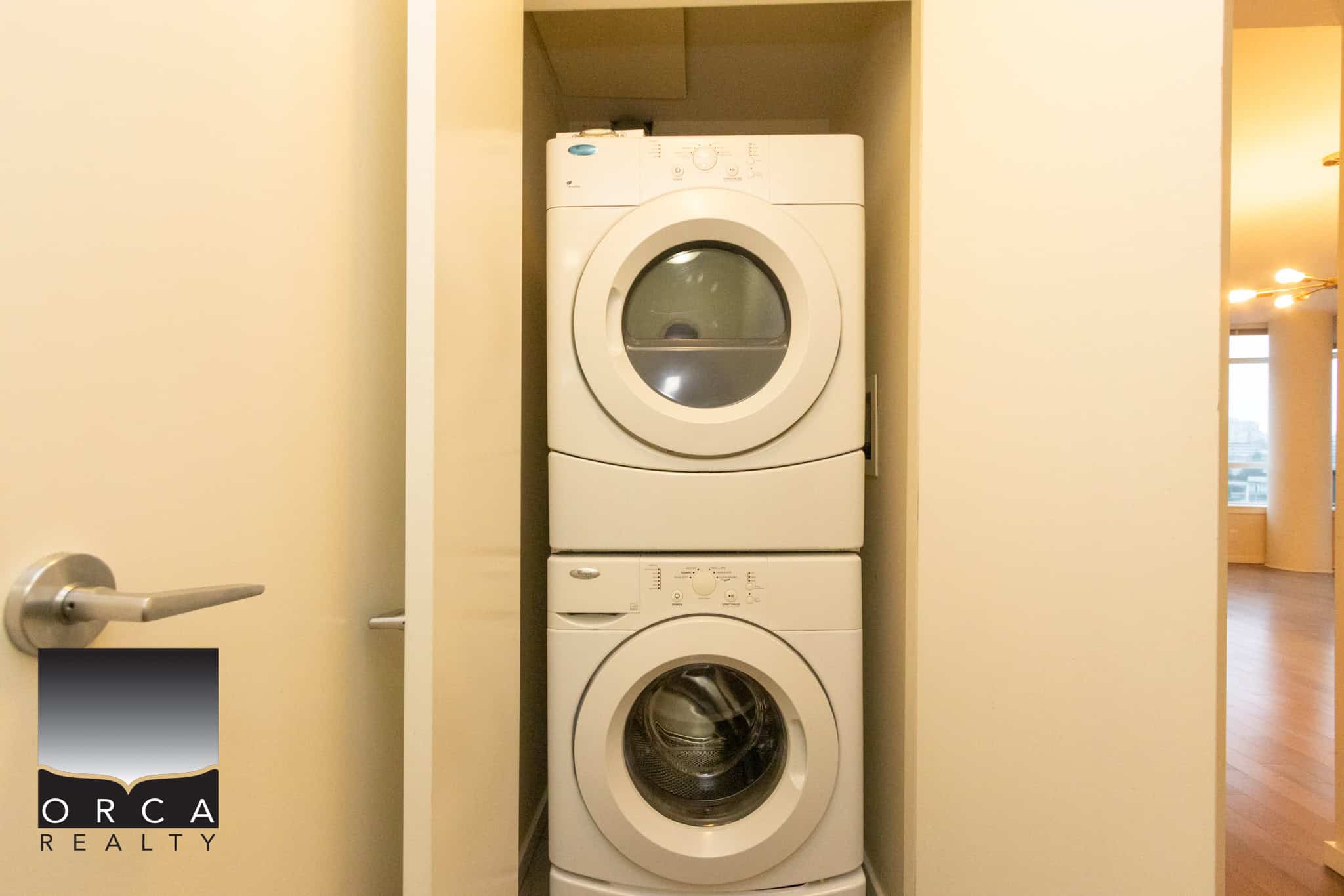 15 (5) Modern laundry closet with stacked washer and dryer, ideal for urban condos and apartments, showcasing efficient space utilization.