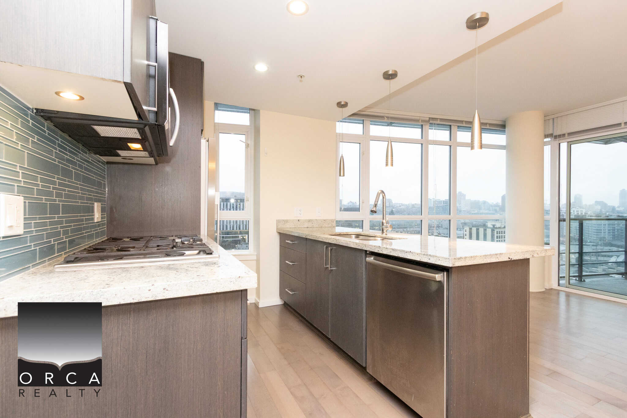 18 (4) Modern upscale kitchen in a high-rise Toronto condo with sleek cabinetry, granite countertops, stainless steel appliances, and abundant natural light. Perfect for luxury Toronto apartment living.