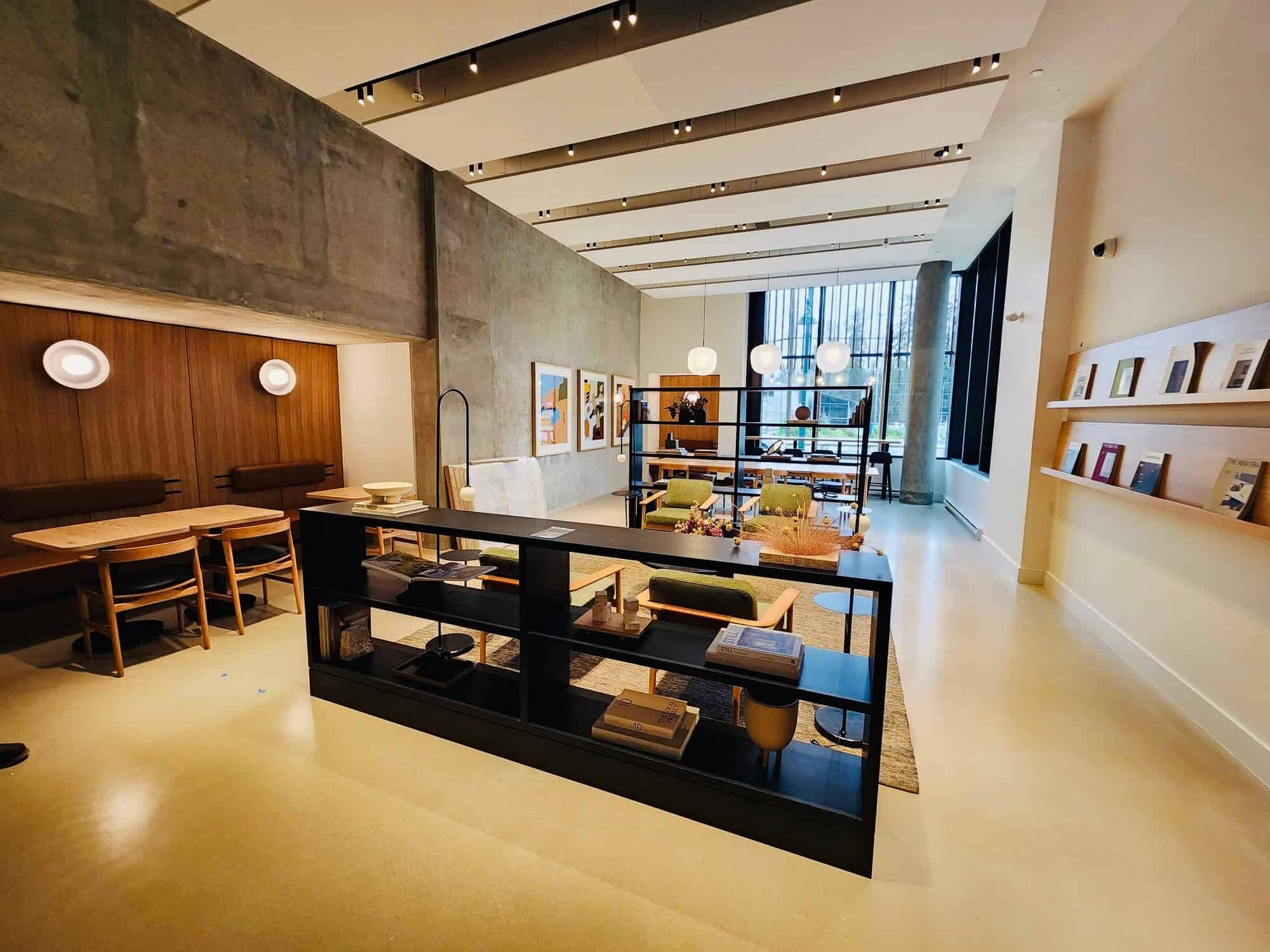 Modern interior office space with contemporary furniture, large windows, and artistic decor reflecting professional real estate services by Orca Realty Inc.