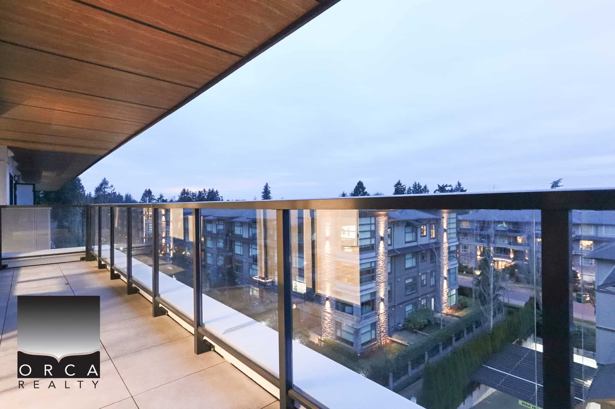 Stunning balcony view from a modern condo in Vancouver, BC, showcasing urban residential buildings and scenic surroundings, perfect for real estate and property investment in Vancouver.
