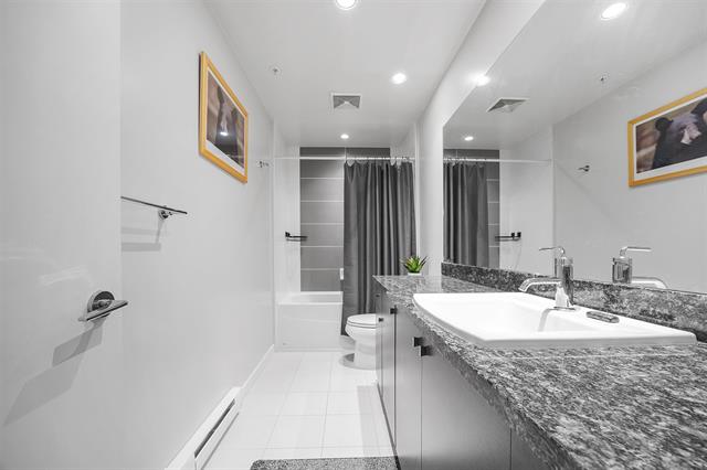 Modern bathroom with sleek design, double sink vanity, granite countertop, and contemporary fixtures, perfect for luxury home living in Vancouver, BC.