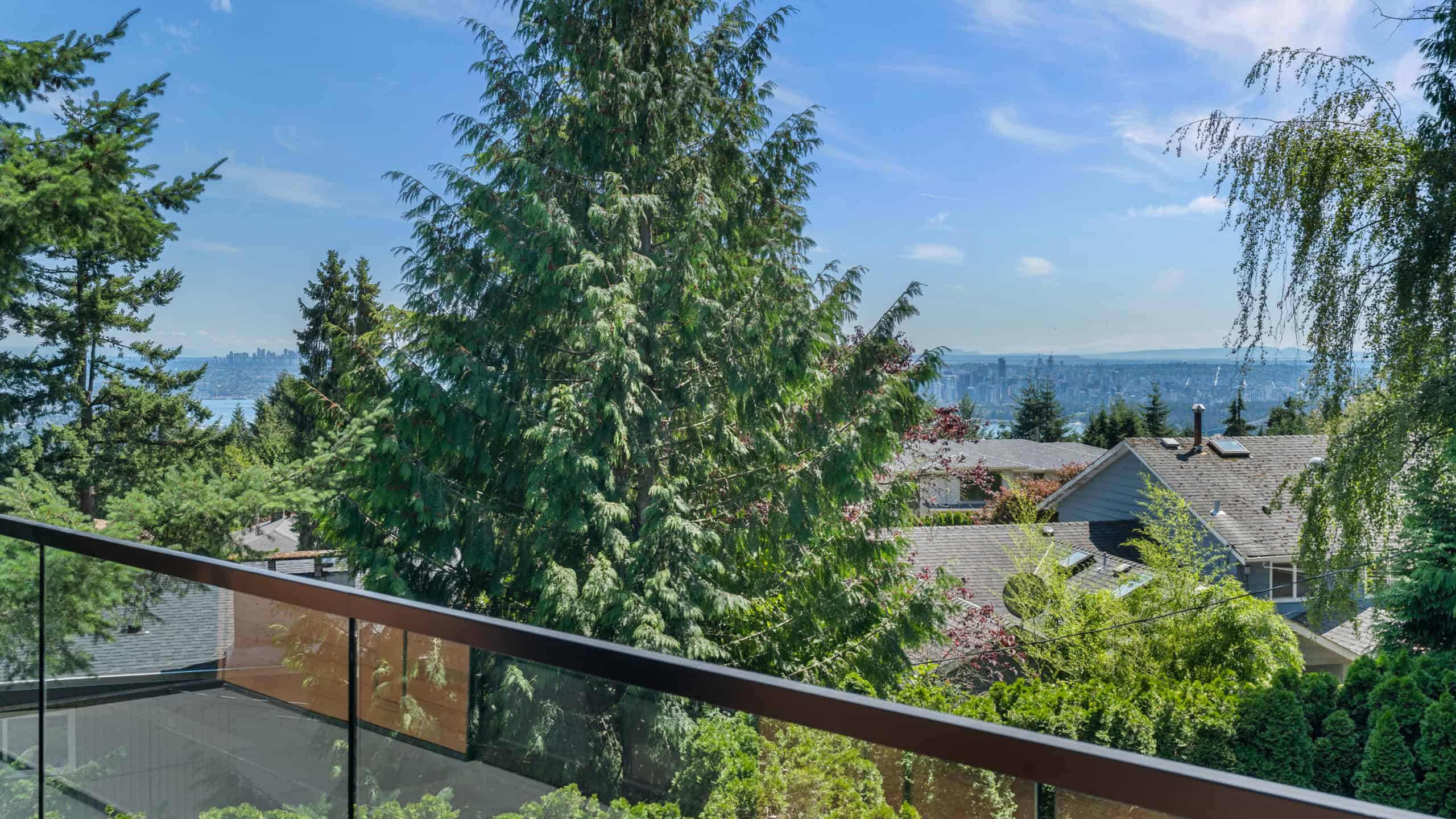 Elegant West Vancouver Home with Scenic Views Beautiful West Vancouver residential scene with lush greenery and ocean views, showcasing a peaceful neighborhood near 865 Andover Crescent.