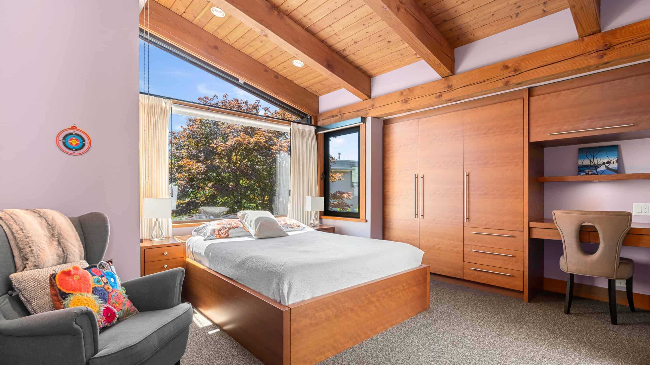 Modern West Vancouver Bedroom with Natural Light Bright and spacious bedroom in West Vancouver featuring large windows, wooden accents, and contemporary furnishings. Perfect for a luxurious home or real estate showcase.