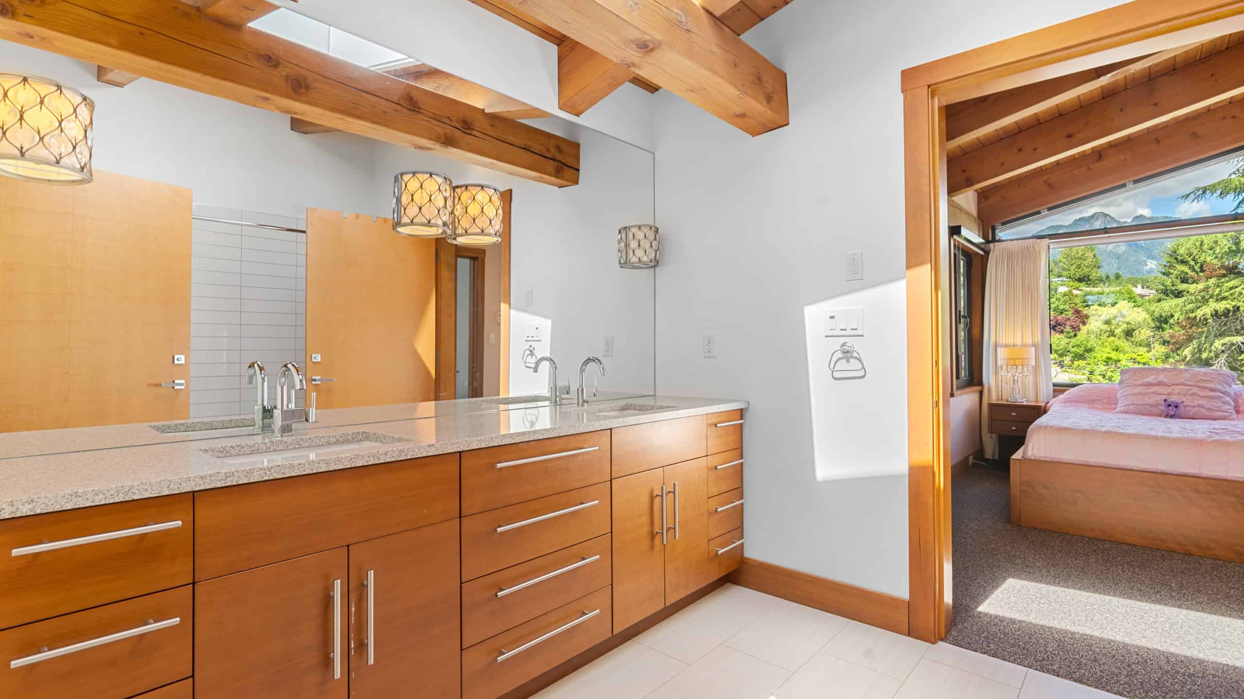 Modern West Vancouver Home Interior Bright and spacious kitchen with wooden cabinets and open doorway leading to a cozy bedroom in a West Vancouver residence.