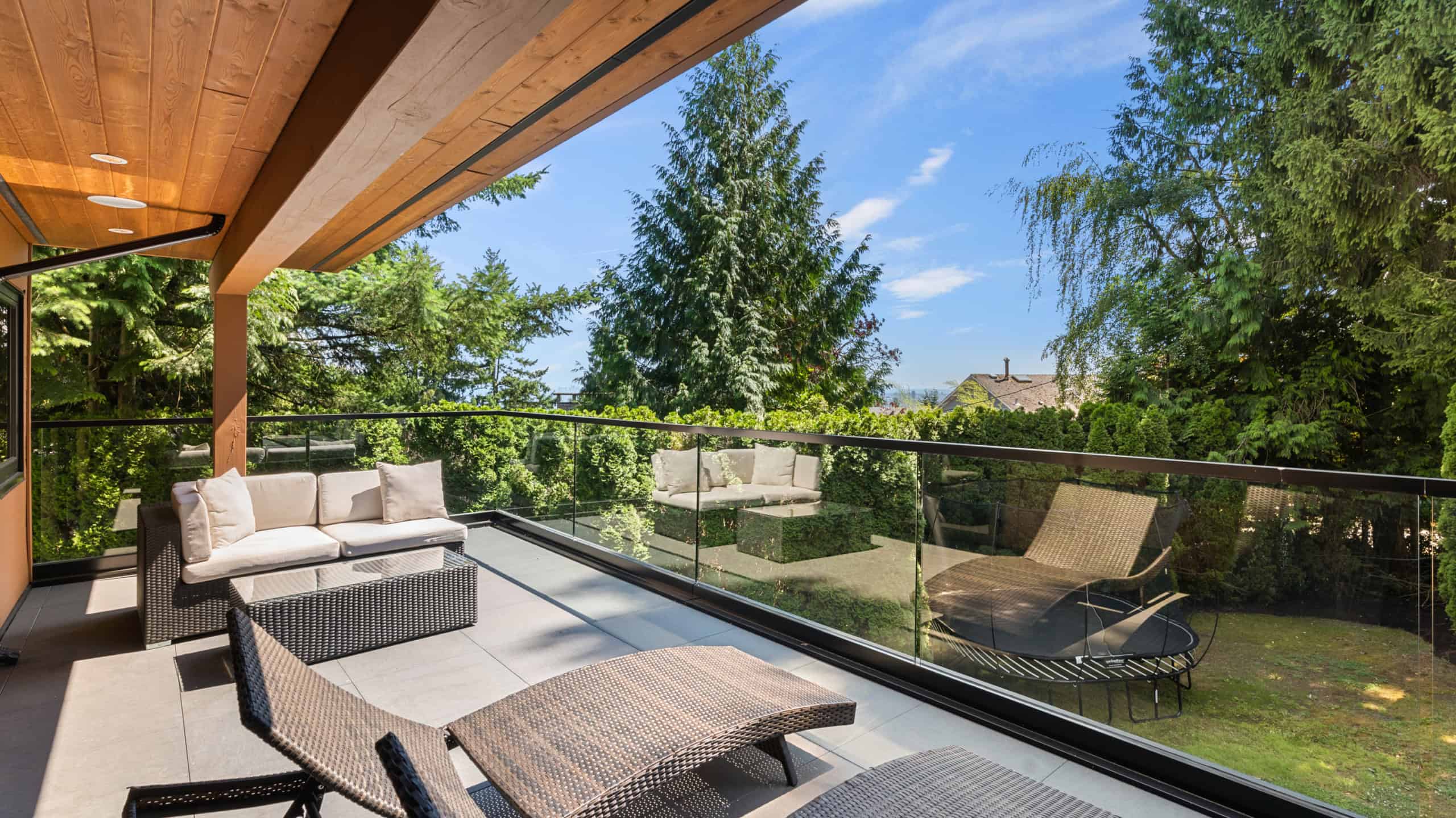 Luxury West Vancouver Balcony with Garden View Spacious balcony overlooking lush greenery in West Vancouver, perfect for relaxing or entertaining. Features comfortable outdoor seating and modern design elements.