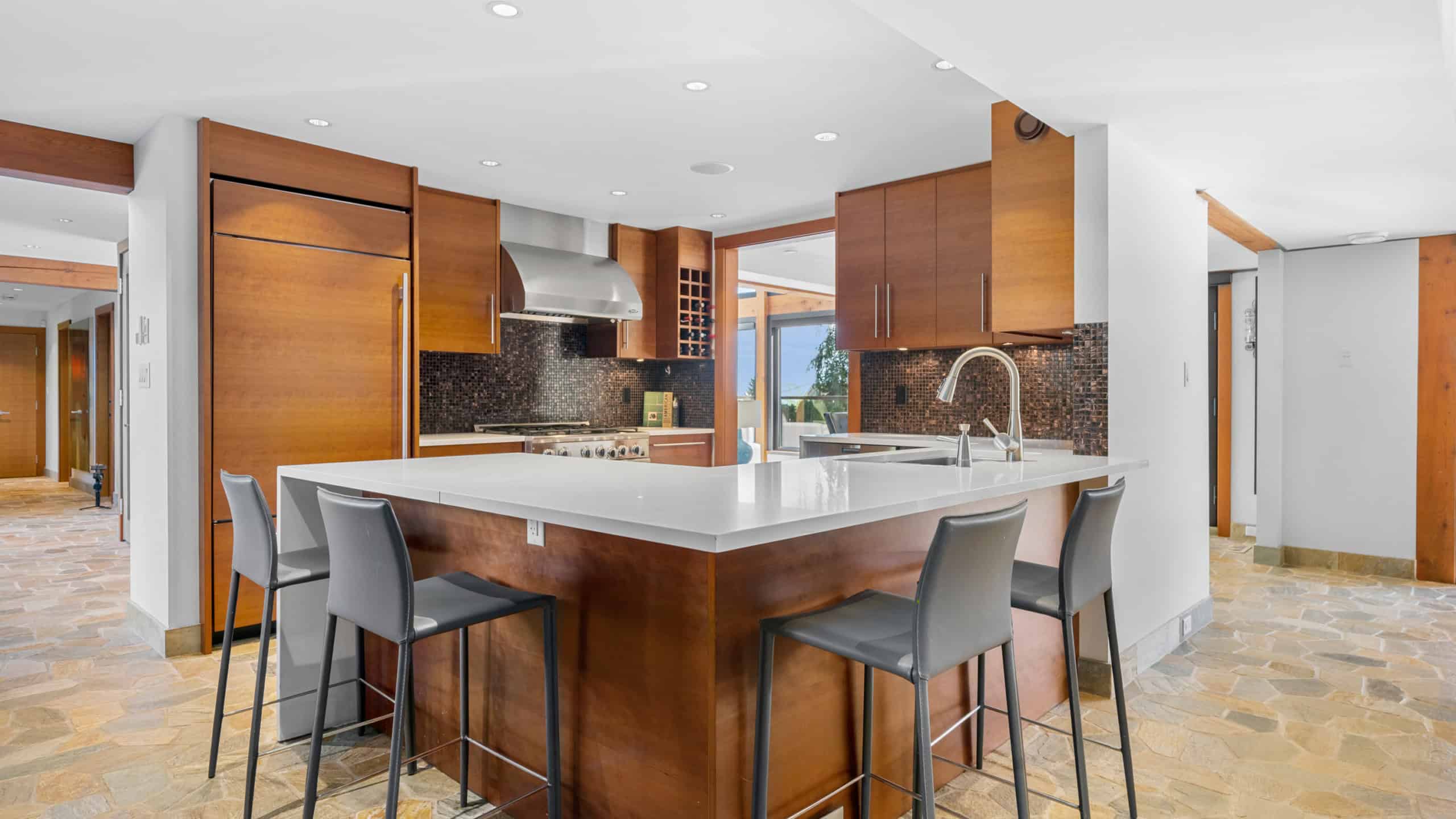 Modern West Vancouver Kitchen with Island Spacious West Vancouver kitchen featuring a large island, wooden cabinetry, and contemporary appliances, perfect for family living and entertaining.