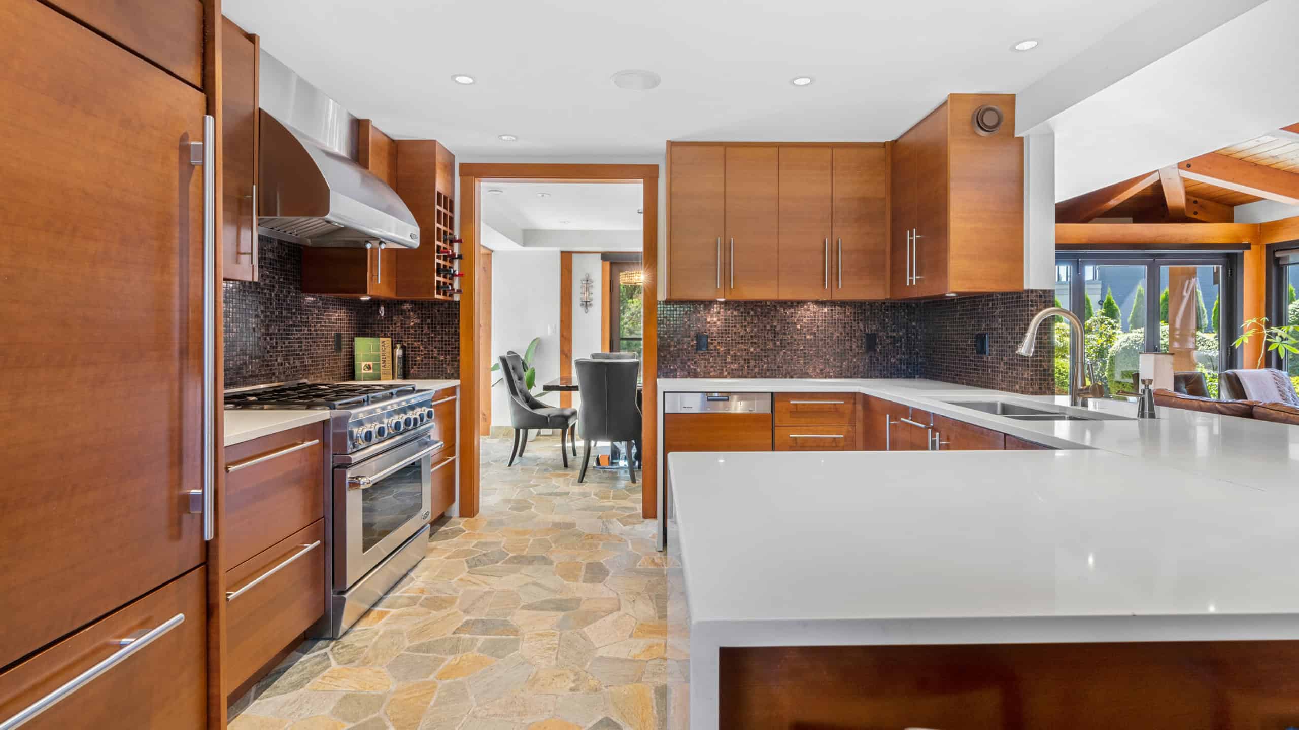 Modern West Vancouver Kitchen with Wooden Cabinets Bright and spacious West Vancouver kitchen featuring wooden cabinetry, stainless steel appliances, and a large island for cooking and entertaining.