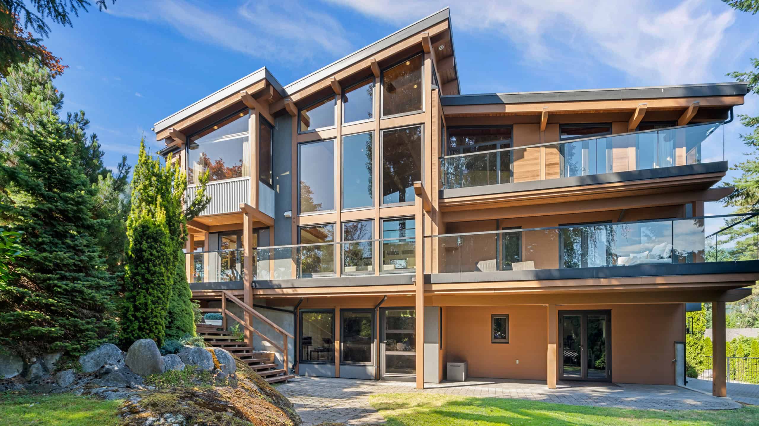 Modern West Vancouver Home with Large Windows and Balconies Contemporary West Vancouver residence featuring expansive glass windows, multiple balconies, and natural wood accents, located at 865 Andover Crescent.
