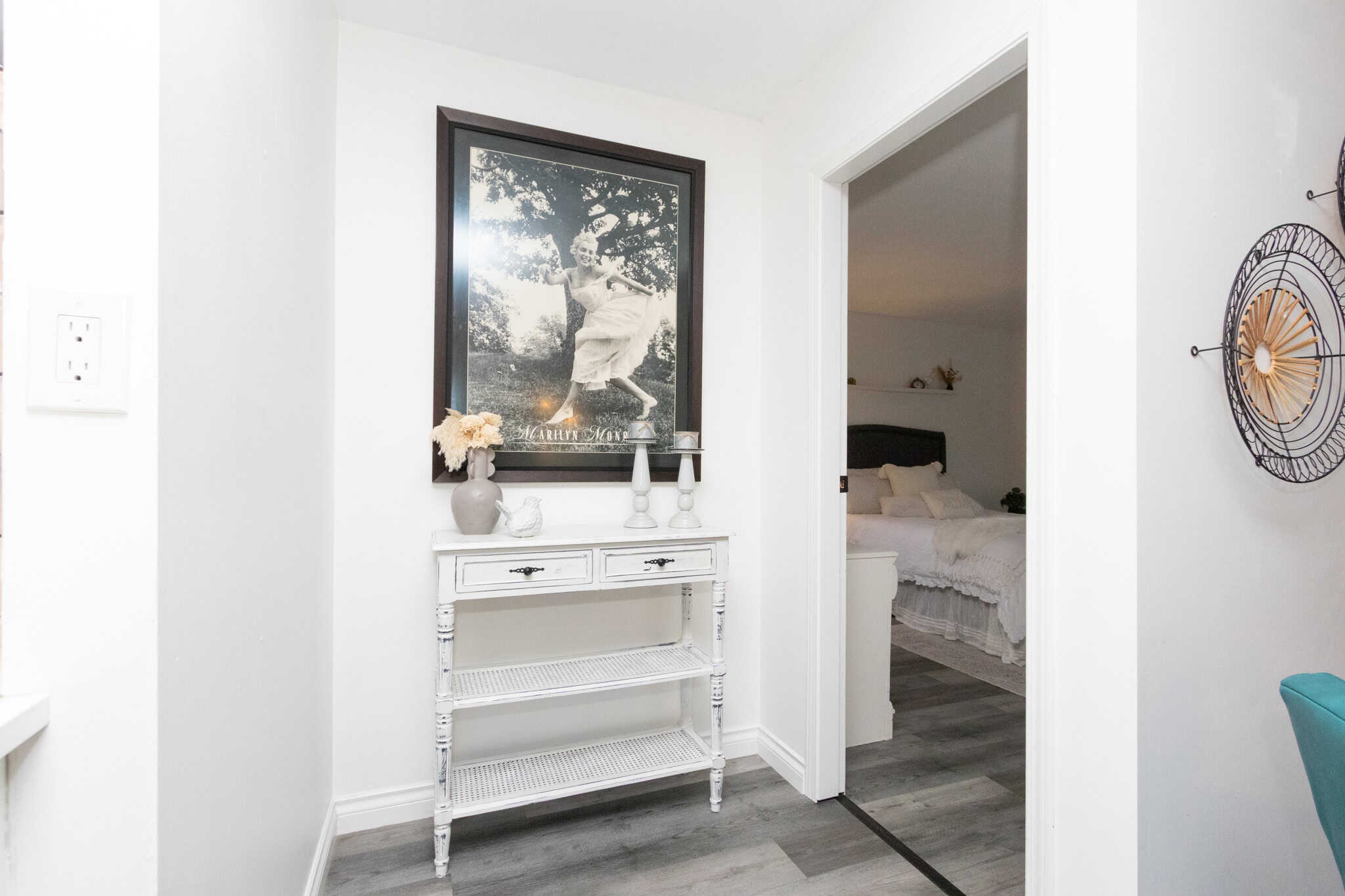 Charming modern home interior with white walls, artwork, and cozy bedroom, showcasing premium real estate in Vancouver by Orca Realty Inc.