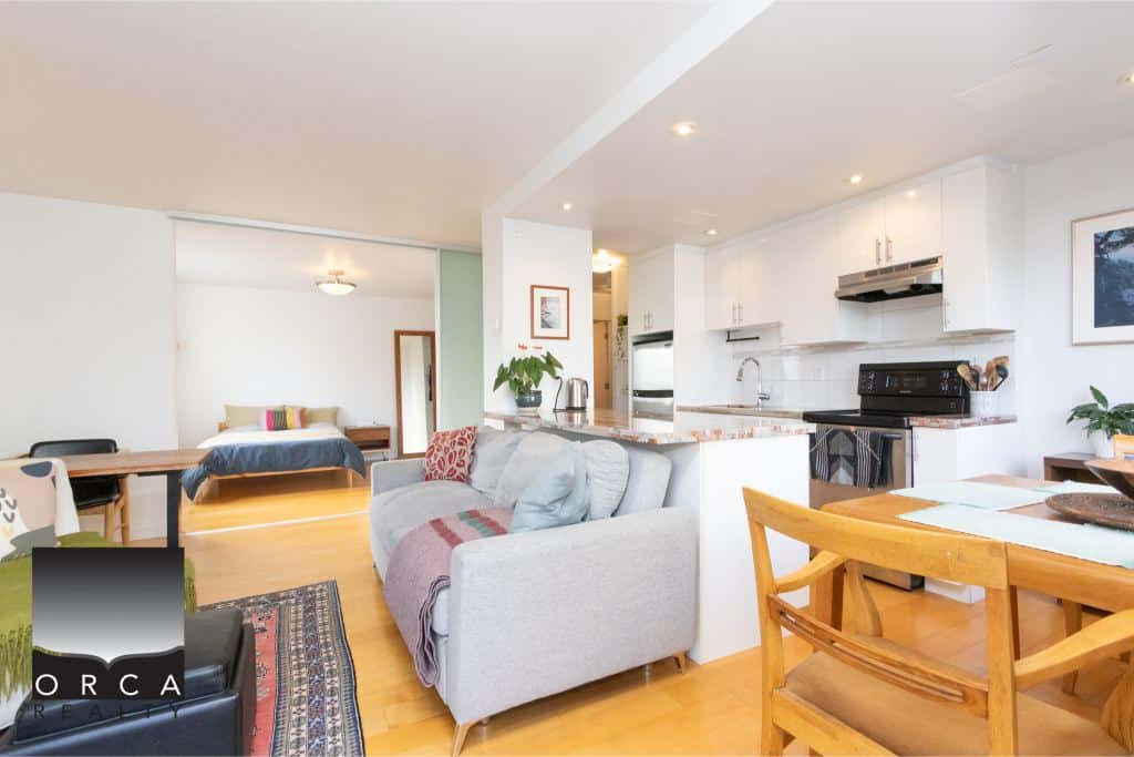 Bright open-concept kitchen and living space in Vancouver, BC, featuring modern appliances, cozy seating, and stylish decor, ideal for comfortable living and entertaining.