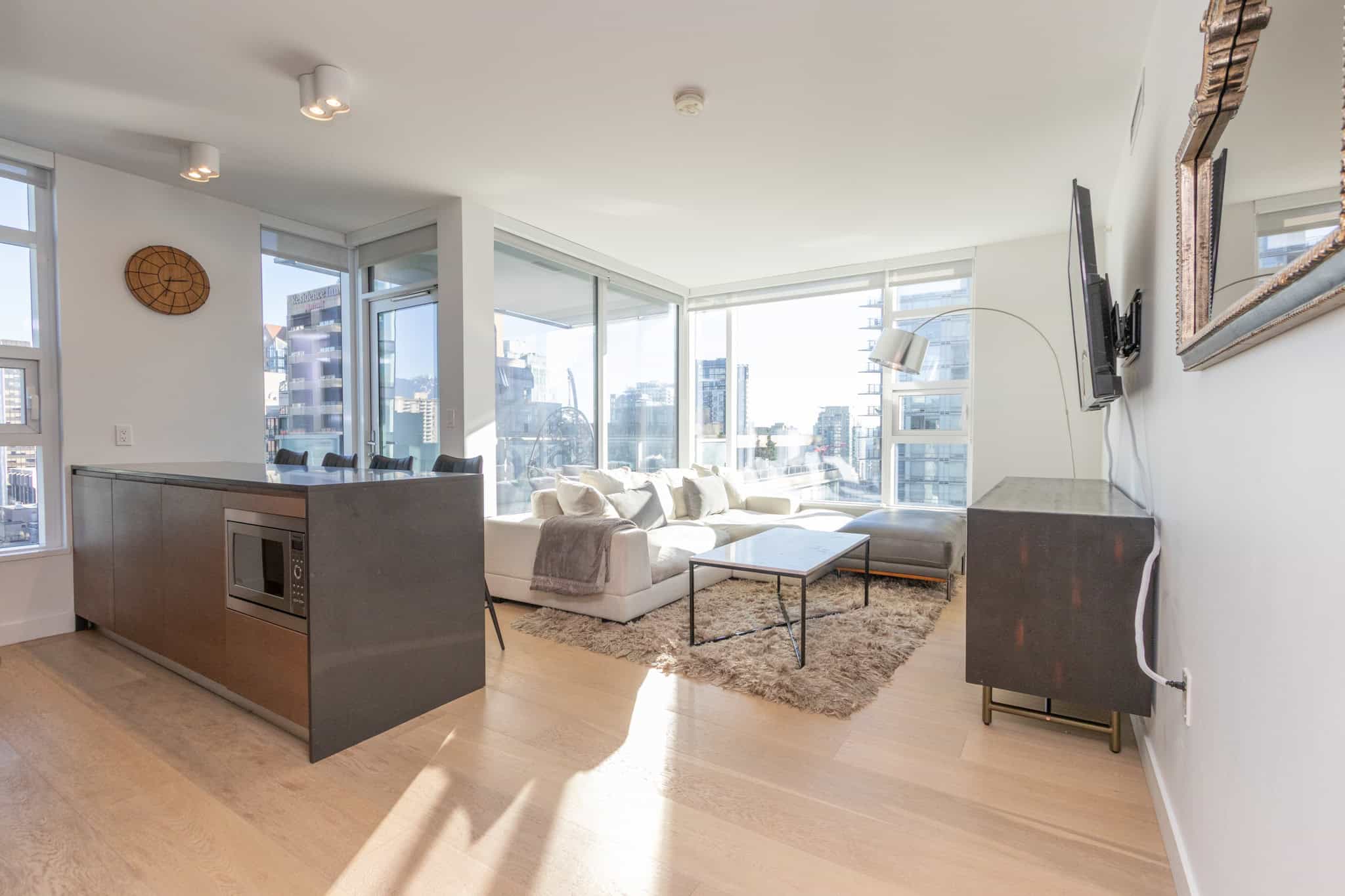Bright Vancouver condo interior with large windows and city views.