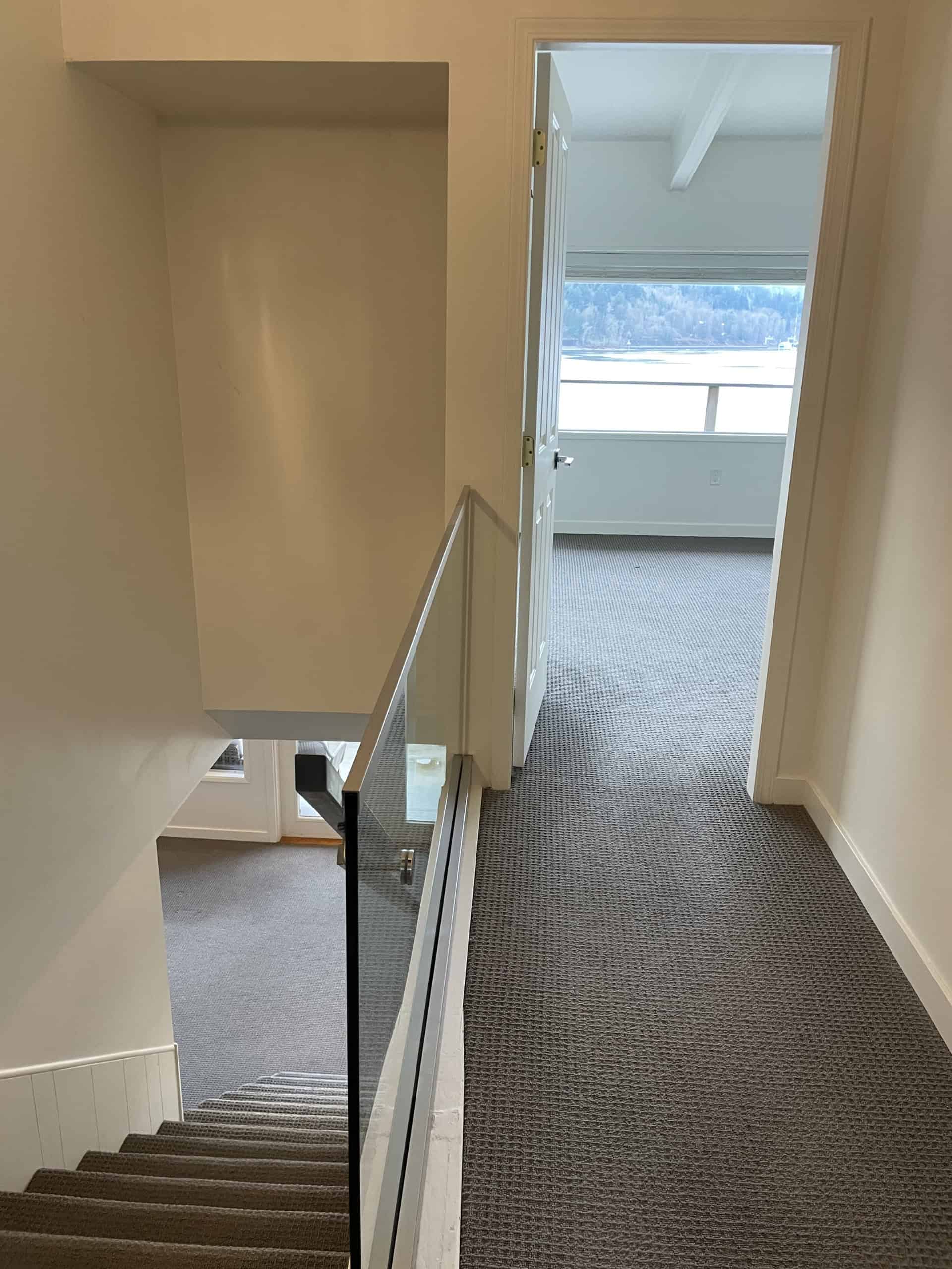 Bright interior hallway of a modern home showcasing spaciousness and natural light in British Columbia.