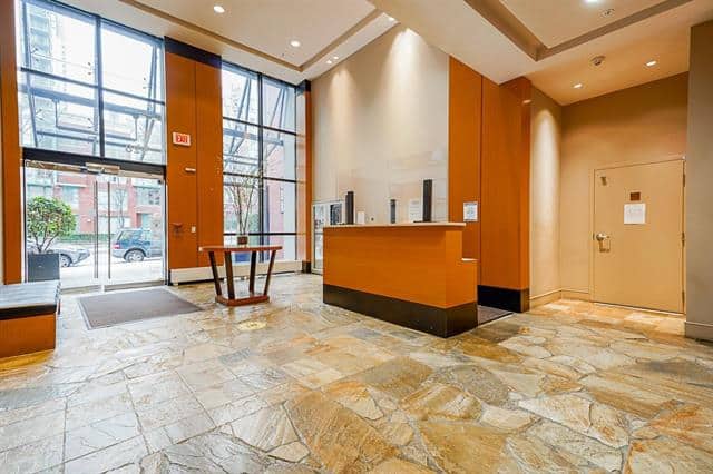 Bright Vancouver condo lobby with large windows, welcoming reception area, and contemporary design.