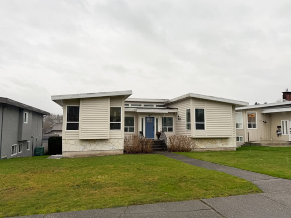 Beautiful contemporary house in Burnaby with a well-maintained lawn and inviting entrance, ideal for families seeking a comfortable and stylish residence.