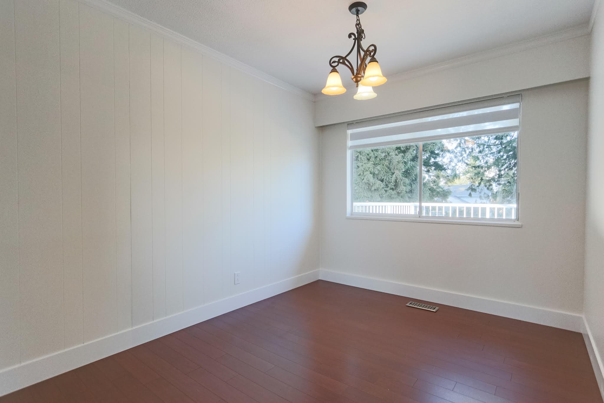 Upstairs living room with large window and ceiling light fixture in Delta property.