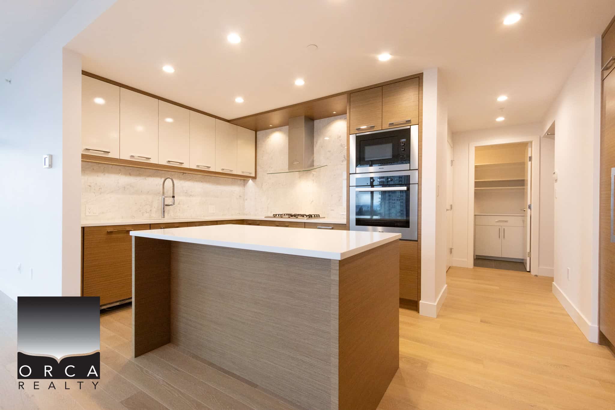Spacious kitchen featuring sleek cabinetry, stainless steel appliances, and a central island, perfect for cooking and entertaining in the Vancouver property at 1106-4360 Beresford Street.