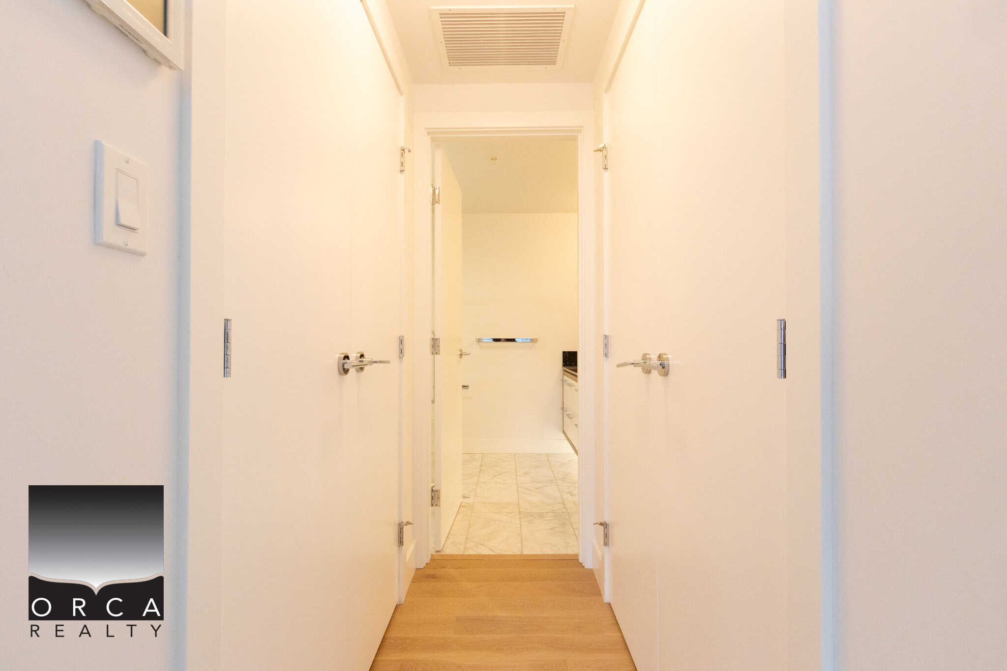 Bright, clean hallway leading to a spacious kitchen in a Vancouver property listed by Orca Realty Inc.