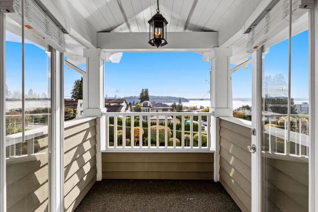 Bright enclosed porch with scenic views of West Vancouver and surrounding neighborhood, perfect for relaxing or enjoying outdoor scenery.