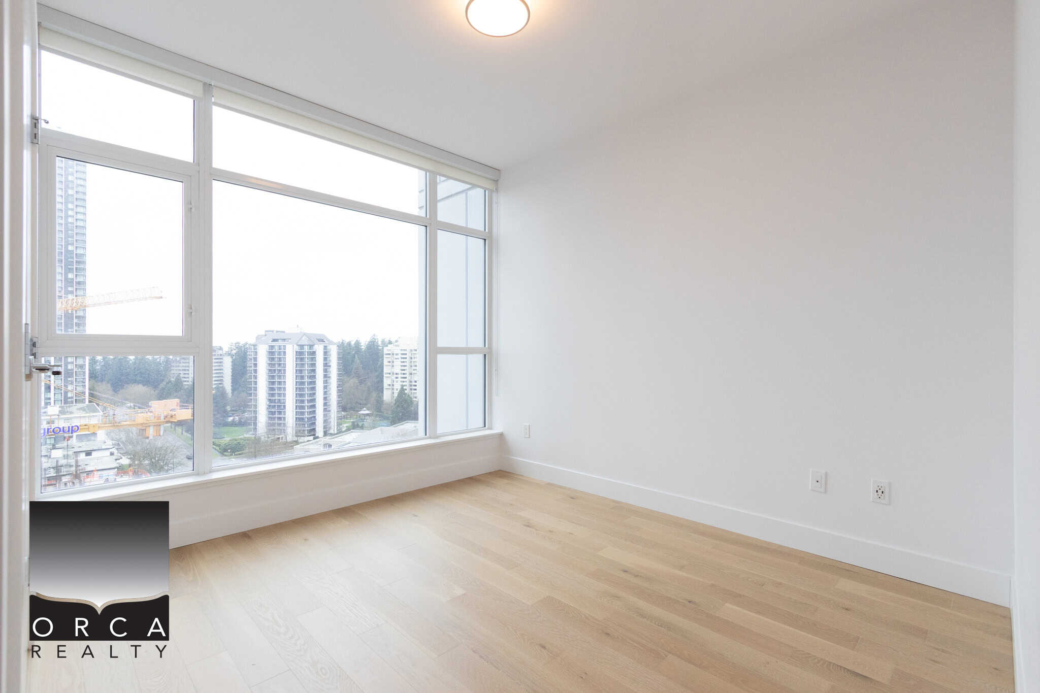 Spacious interior of 1106-4360 Beresford Street, Vancouver, showcasing large windows, natural light, and a clean, contemporary design ideal for urban living.