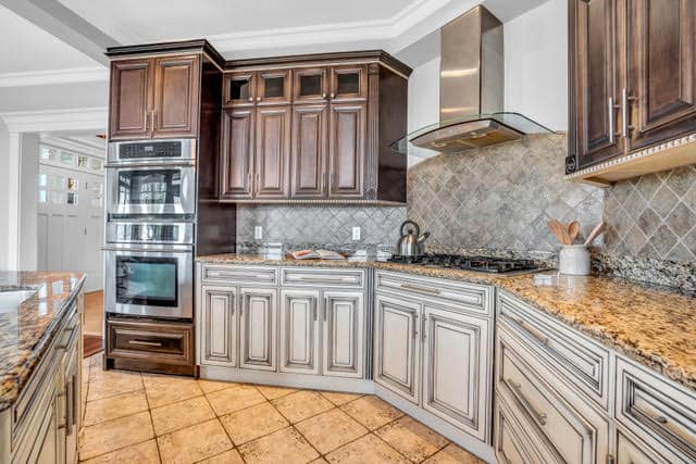 Elegant kitchen featuring custom dark and light wood cabinets, granite countertops, and stainless steel appliances in West Vancouver. Perfect for family living and entertaining.