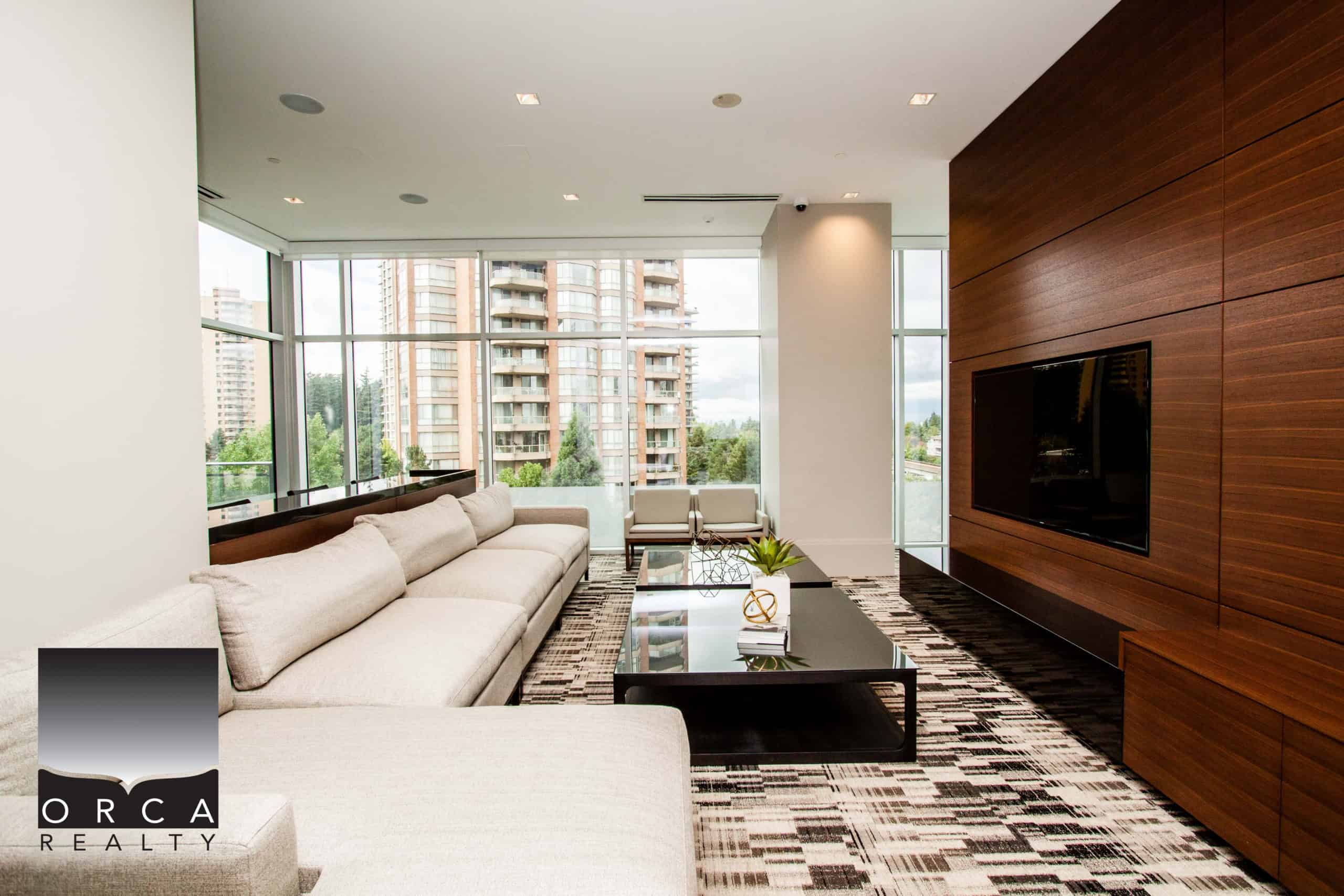 Contemporary living room in Vancouver with spacious seating, large windows, and cityscape views, showcasing upscale interior design and natural light.