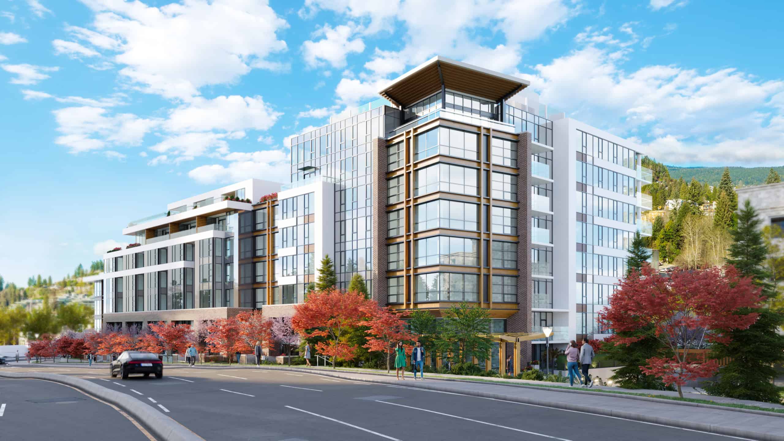 Bright, contemporary condo building in West Vancouver with large glass windows and scenic mountain views.
