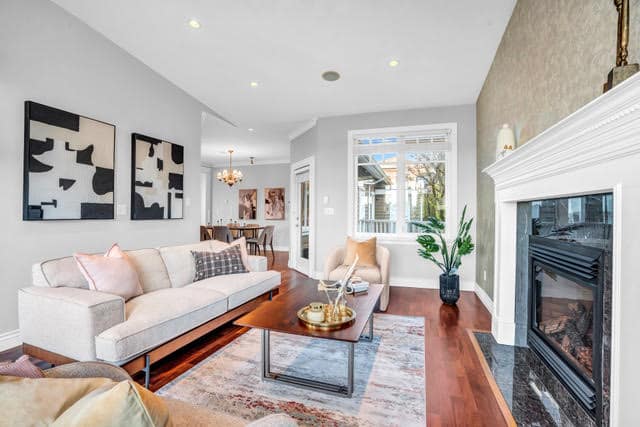 Modern West Vancouver living room featuring a cozy fireplace, stylish decor, and large windows offering natural light. Perfect for relaxing or entertaining in a beautiful home at 1197 Fulton Avenue.