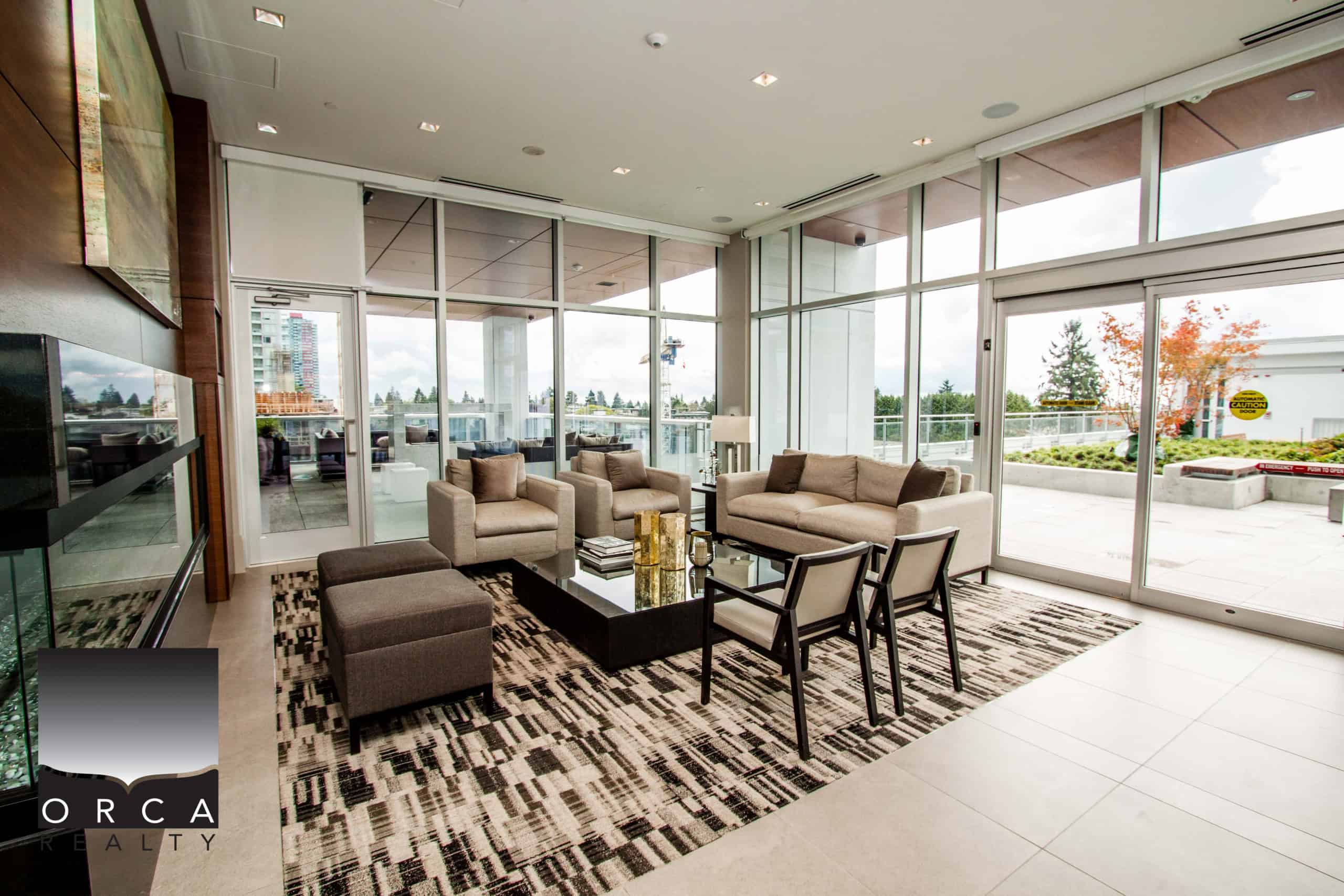 Spacious living room in a luxury Vancouver condo at 1106-4360 Beresford Street, featuring large windows, contemporary furniture, and a stylish interior design.