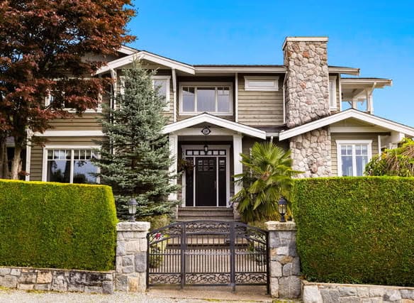 Spacious West Vancouver residence at 1197 Fulton Avenue featuring lush greenery, manicured hedges, and a charming stone pathway leading to a stylish front entrance. Perfect for luxury living.