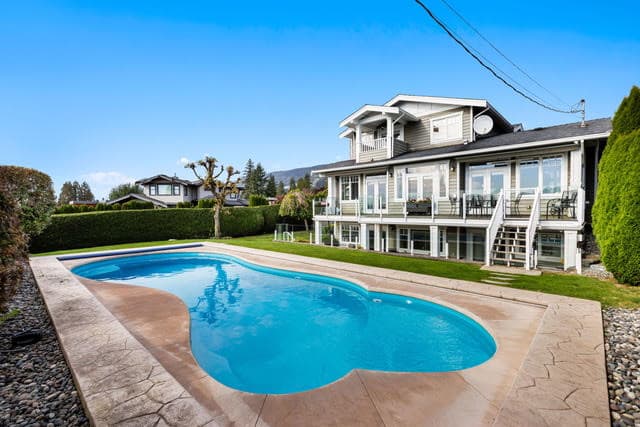 Spacious West Vancouver property with a private swimming pool and stunning ocean views, perfect for luxury living and entertaining.