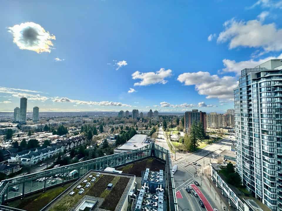 Panoramic view of Edmonds Street in Burnaby, showcasing urban development, residential towers, and scenic sky with clouds.