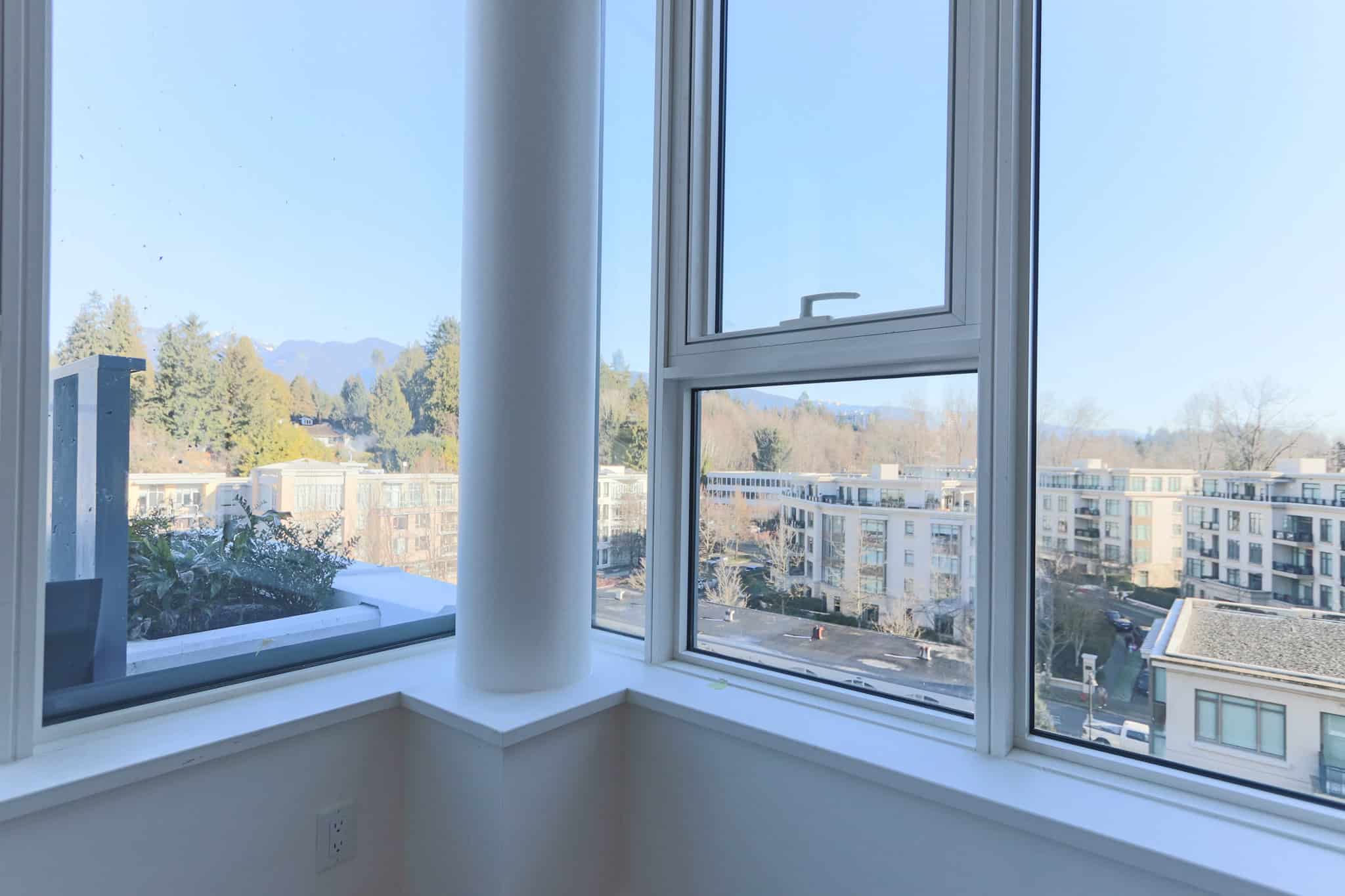 Bright West Vancouver apartment with panoramic city and mountain views.